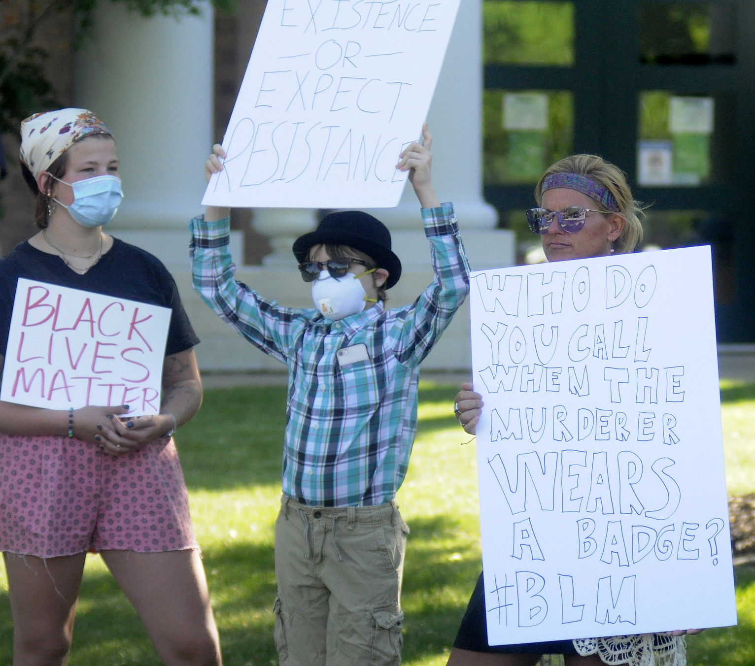 Demonstrators hold signs